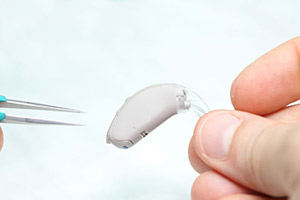 Close up of hearing aid being repaired