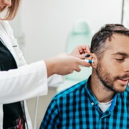 Middle age man at medical examination or checkup at audiologist's office