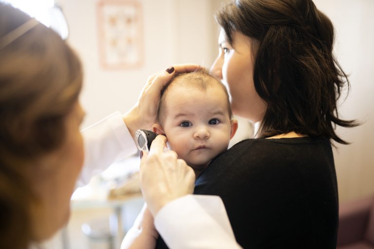 A baby gets an ear exam.
