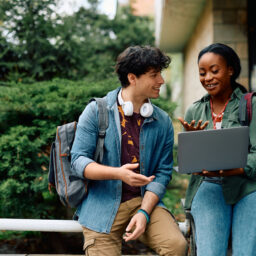 College students reviewing their notes on a laptop